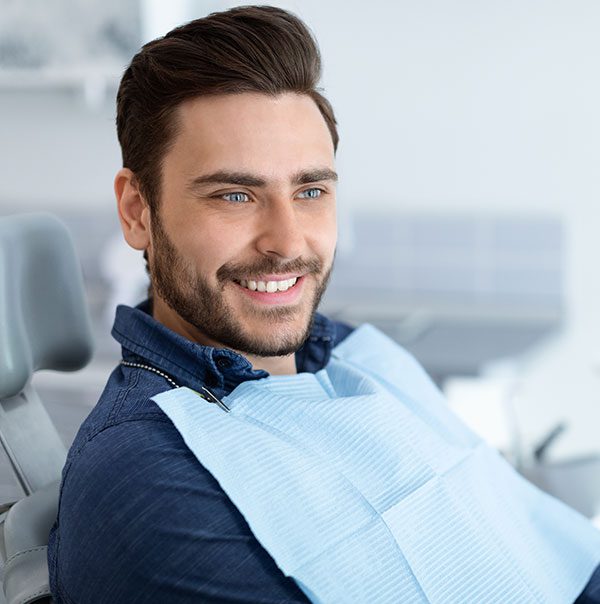 relaxed-man-smiling-to-his-dentist